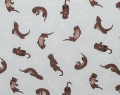 an image of monkeys on white fabric with brown and blue swirls in the background