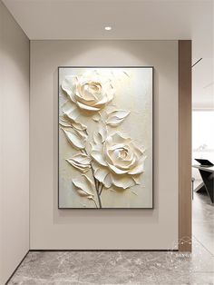 a white flower painting hanging on the wall