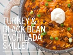 turkey and black bean enchilada skillet with sour cream in the middle