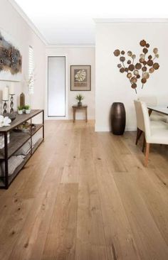 a living room with hardwood floors and white walls