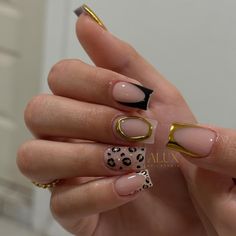 a person with some nail polish on their hands and one has a leopard print design