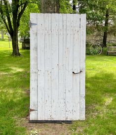 an old wooden door is in the grass