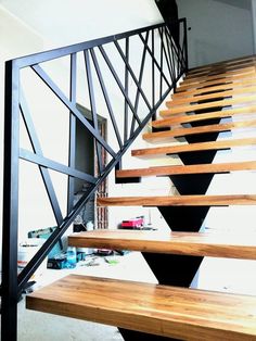 there is a set of wooden stairs with metal railings on the top and bottom