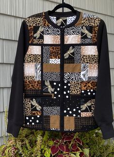 an animal print jacket is hanging on a clothes hanger in front of a house