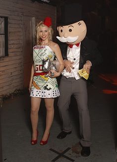 a man and woman dressed in costumes standing next to each other