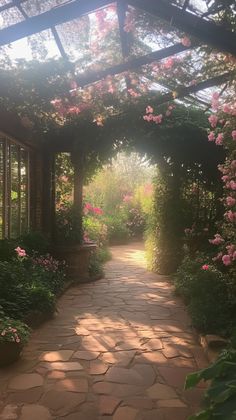 a walkway that has flowers growing on it