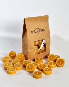 a brown paper bag filled with yellow candles