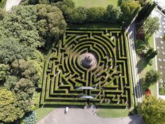 an aerial view of a maze in the middle of a park