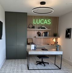 an office with a desk and shelves on the wall, along with a lamp that reads lucas