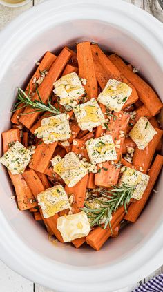 a white bowl filled with carrots and cheese