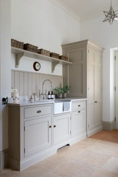 an image of a kitchen with white cabinets and counter tops in the middle of it