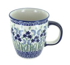 a blue and white coffee cup with flowers on it