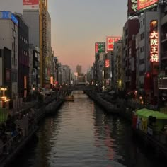 a river running through a city next to tall buildings