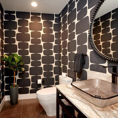 a modern bathroom with black and white wallpaper