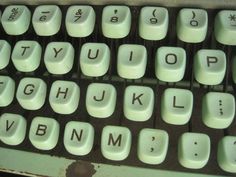 an old computer keyboard with letters and numbers on the keys are white, but not black