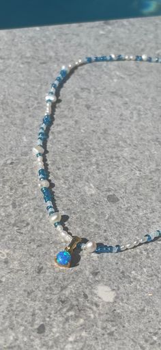 Beautiful blue seed bead necklace with real freshwater pearls, 24 karat gold plated details and a beautiful opal imitation charm. Necklace is approximately 42 cm long + 3 cm extend chain. Beaded measure between 3-5 mm in size. Beaded Pearl Necklace, Blue Opal Necklace, Blue Beaded Necklace, Necklace Pearl, Necklace Beaded, Necklace Blue, Seed Bead Necklace, Opal Necklace, Blue Opal