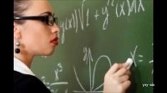 a woman writing on a blackboard with white chalk