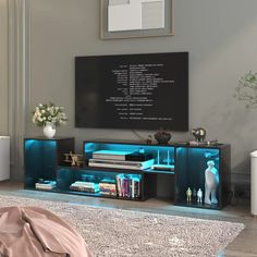 a living room with a large television on the wall and blue lights in it's cabinet