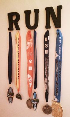 medals are hung on the wall to spell out run