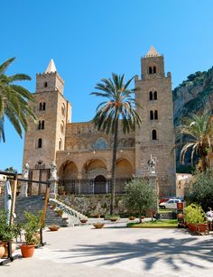 an old building with palm trees in front of it