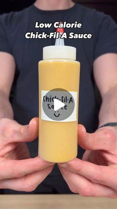 a person holding a bottle of mustard in front of their hands with the caption, low calorie chick - fil sauce