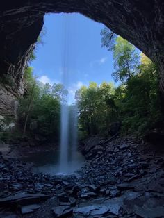 an image of a waterfall coming out of a cave