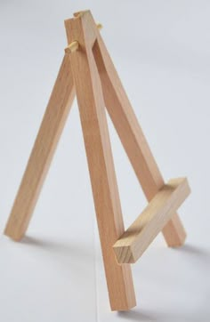 a wooden easel sitting on top of a white table