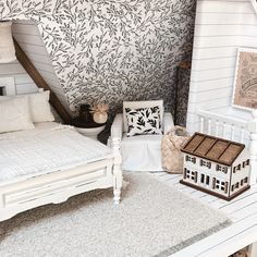 a doll house bedroom with white furniture and accessories on the floor, including a bed