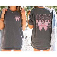 Dance your heart out in style with our "Dance" Shirt featuring a Coquette Bow! 💃🎀 This fashionable and comfortable shirt is perfect for every dancer who loves to add a touch of elegance to their dancewear. Featuring the word "Dance" paired with a cute coquette bow, this shirt is the ideal way to celebrate your passion for dance with flair. 🎨 Vibrant and Trendy Colors: Available in a variety of fashionable colors, this shirt is designed to match your style. Choose your favorite shade and proud Dance Team Shirts Ideas High Schools, Casual Summer T-shirt For Dance, Fitted Short Sleeve T-shirt For Cheerleading, Casual Short Sleeve Dance Tops, Casual Short Sleeve T-shirt For Dance, Casual Short Sleeve Tops For Dance, Casual Crew Neck Shirt For Dance, Hip Hop Dance Tops With Short Sleeves, Casual Dance Shirt With Graphic Print