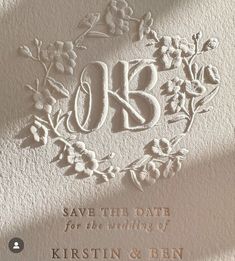 a wedding card with the initials and flowers on it