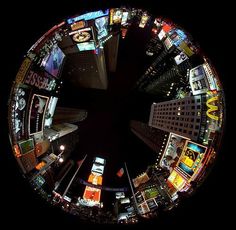 an aerial view of a city at night with lots of neon lights and billboards