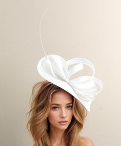 White Kentucky Derby Hat & Ascot Fascinator Hats White Avery Kentucky Derby Fascinator White Free form base trimmed with bow loops and a quill Fascinator base measures 14 inches wide This hatinator is mounted with a matching headband. If you prefer a headband to match your hair, please make a note at check out what colour headband you want. This Fascinator hat is perfect for any special occasion like a wedding, bridal shower or ladies day at the races such as Royal Ascot, Kentucky Derby, Kentucky Oaks, and Melbourne Cup. We make each hat to order just for you, we would prefer if you did not order for choice. If colour match is important to you please ask for free fabric swatch to be sent to you - this reduces returns and disappointment.   We can also make a custom design for you if you hav Wedding Guest Fascinators, Wedding Hats For Guests, Kentucky Oaks, White Fascinator, Kentucky Derby Fascinator, Occasion Hats, Day At The Races, Ascot Hats, Base Trim