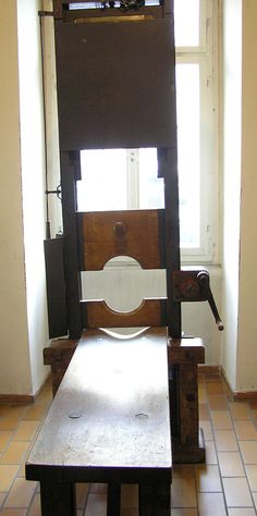 an old wooden chair sitting in front of a window