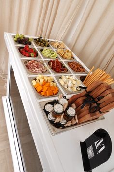 an assortment of food is displayed on a buffet table with utensils and snacks