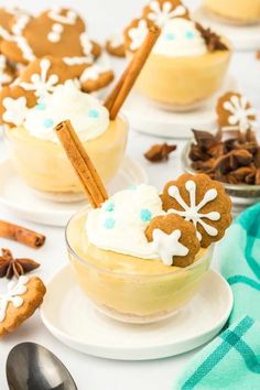 two desserts are sitting on plates with spoons and cinnamon sticks sticking out of them