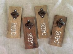 three wooden bottle openers with the words cheers and chefs on them sitting on a bed