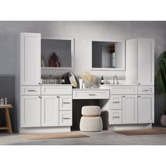 a bathroom with white cabinets and mirrors