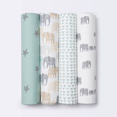 three rolls of baby swaddles in various patterns and colors, each with an elephant design