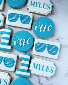 decorated cookies with blue and white stripes are arranged in the shape of sunglasses, one for each other