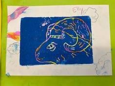 a child's drawing of a sheep on a blue and green paper with clouds in the background