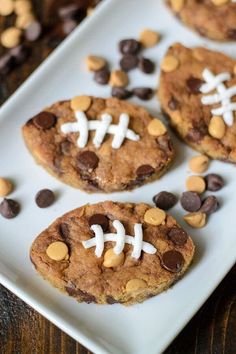 chocolate chip cookies decorated with footballs on a white plate