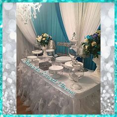 an image of a table set up for a wedding reception with blue and white decor