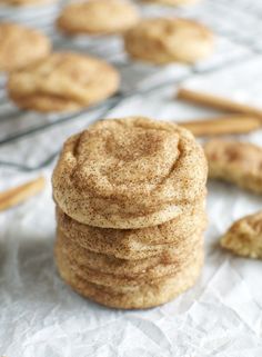 a stack of cookies sitting on top of a table next to some cinnamon stick sticks