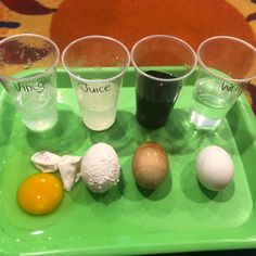 an assortment of different types of food on a green tray with juice, eggs and ice cream