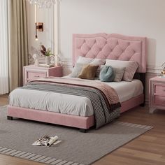 a pink bed sitting in a bedroom on top of a hard wood floor