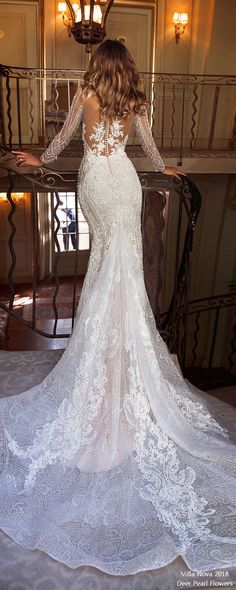 the back of a wedding dress with sheer sleeves