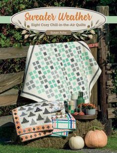 the cover of a quilt book with pumpkins and other things on display in front of it