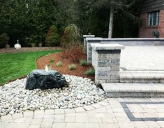 an outdoor patio with stone steps and landscaping