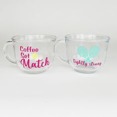 two coffee mugs with designs on them sitting side by side, one has a tennis racket and the other says coffee set match