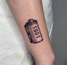 a person with a can tattoo on their arm